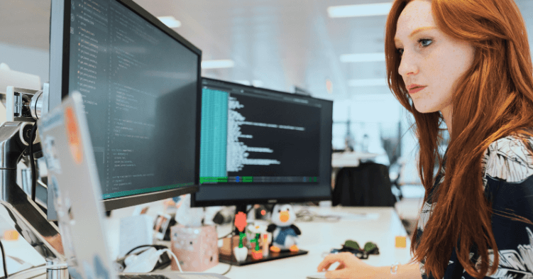 stock image of woman at computer working on ai IT operations